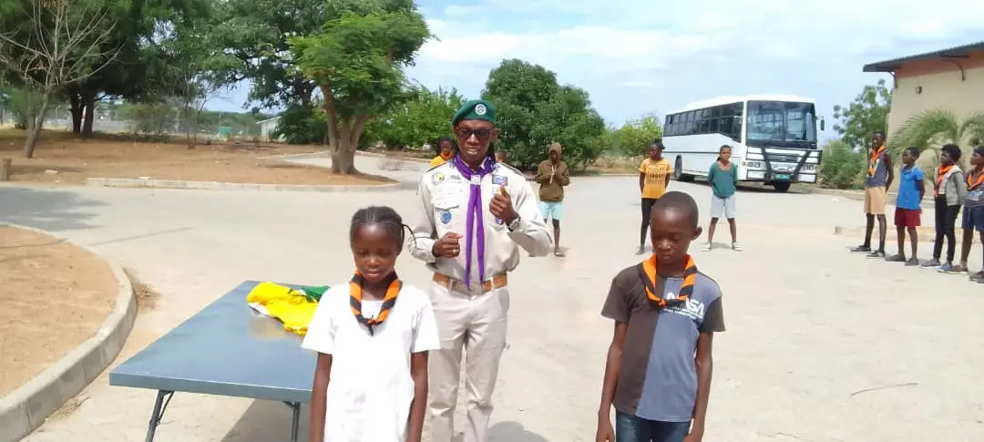 Cubs investiture by Emilazer Michael with two young scouts